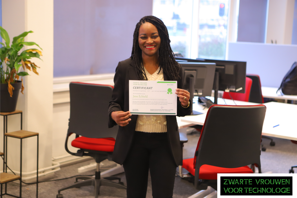 Picture of Jane Echteld standing while holding a ZVVT certificate