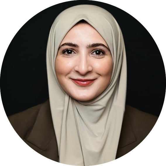 Picture of Imane B'Lyou. Beautiful woman with a sandcolored hijap and brown jacket.