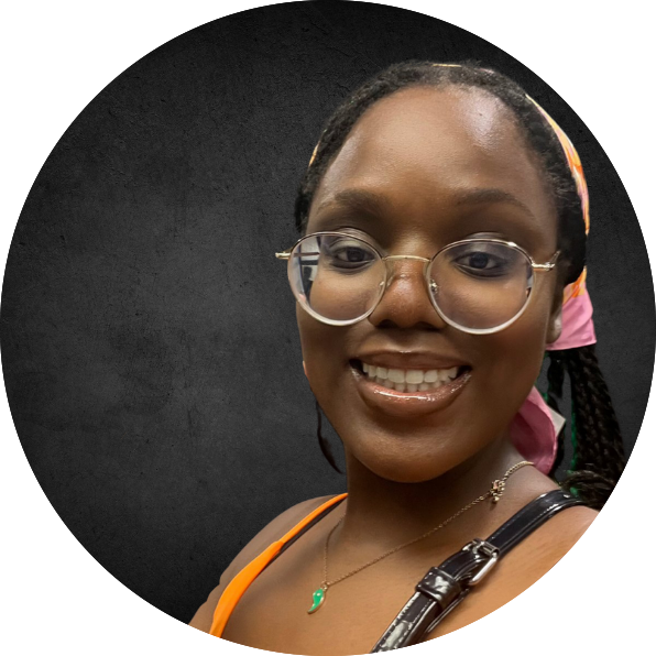 Picture of SuYen Donk. A beautiful black woman with glasses and a orange top
